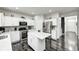 Modern kitchen featuring white cabinets, stainless steel appliances, and a center island with a quartz countertop at 10447 Pintail Ln, Indianapolis, IN 46239