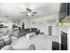 Open-concept living room and kitchen with contemporary decor, a fireplace, and abundant natural light at 10447 Pintail Ln, Indianapolis, IN 46239