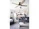 Bright living room with large windows, a comfortable sofa, and a ceiling fan, offering a cozy space for relaxation at 10447 Pintail Ln, Indianapolis, IN 46239