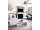 Cozy living room with a fireplace, modern ceiling fan, and decorative shelves perfect for relaxing and entertaining guests at 10447 Pintail Ln, Indianapolis, IN 46239