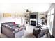 Inviting living room featuring a comfortable sofa, cozy armchairs, a fireplace, and bright natural lighting at 10447 Pintail Ln, Indianapolis, IN 46239