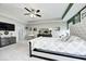 Spacious main bedroom with a ceiling fan, TV, an ensuite bathroom, and natural light at 10447 Pintail Ln, Indianapolis, IN 46239