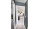 View into the main bedroom featuring a carpeted floor, a vanity with a mirror, and neutral wall paint at 10447 Pintail Ln, Indianapolis, IN 46239