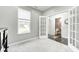 Bright room with French doors leading to the bathroom, showcasing a gray wall and a window at 10447 Pintail Ln, Indianapolis, IN 46239