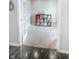 Office/bedroom featuring gray walls, bright carpet, and a storage shelf holding colorful storage containers at 10447 Pintail Ln, Indianapolis, IN 46239