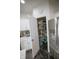 Walk-in pantry with shelving, adjacent to the refrigerator and modern appliances at 10447 Pintail Ln, Indianapolis, IN 46239