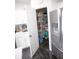 Well-organized pantry with wire shelving, various food items, and convenient access from the kitchen, next to the refrigerator at 10447 Pintail Ln, Indianapolis, IN 46239