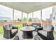Inviting screened porch with wicker furniture, perfect for outdoor relaxation and entertaining at 10447 Pintail Ln, Indianapolis, IN 46239