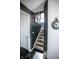 Stylish stairway with dark accent wall and visible decor, providing a modern touch to the home's interior at 10447 Pintail Ln, Indianapolis, IN 46239