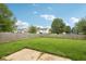 A spacious backyard featuring a lush green lawn and a wooden fence at 1093 Country Meadow Ct, Franklin, IN 46131