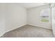 A view of the bedroom with neutral carpeting and a window for natural light at 1093 Country Meadow Ct, Franklin, IN 46131