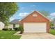 Charming home with a two-car garage featuring a brick facade and well-maintained landscaping at 1093 Country Meadow Ct, Franklin, IN 46131
