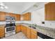 A view of the kitchen featuring oak cabinets, granite countertops, and stainless steel appliances at 1093 Country Meadow Ct, Franklin, IN 46131