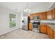 A view of the kitchen with stainless steel appliances, oak cabinets, and granite countertops at 1093 Country Meadow Ct, Franklin, IN 46131