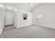 Spacious living room featuring plush carpet, a window, and a pass through to the kitchen at 1093 Country Meadow Ct, Franklin, IN 46131