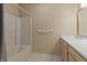 Cozy bathroom with tub/shower, modern sink, and neutral wall color at 11226 Blackwalnut Pt, Indianapolis, IN 46236