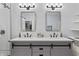 Stylish bathroom features double vanity with stone countertops and modern lighting fixtures at 11226 Blackwalnut Pt, Indianapolis, IN 46236