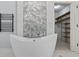 Luxurious bathroom with freestanding tub, heated towel rack and walk-in closet at 11226 Blackwalnut Pt, Indianapolis, IN 46236