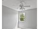 Bright bedroom featuring light grey walls, a large window, and a ceiling fan at 11226 Blackwalnut Pt, Indianapolis, IN 46236