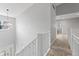 Upstairs hallway with chandelier, and neutral paint color at 11226 Blackwalnut Pt, Indianapolis, IN 46236
