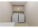 Well-lit laundry room has a full size washer, dryer and storage cabinets at 11226 Blackwalnut Pt, Indianapolis, IN 46236