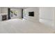 Open-concept living room with a fireplace, tile flooring, and a view of a deck at 11226 Blackwalnut Pt, Indianapolis, IN 46236