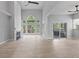 Open living room with a fireplace, high ceilings, natural light, and access to the back deck at 11226 Blackwalnut Pt, Indianapolis, IN 46236