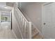 Stairway with light wood flooring and white railings at 11226 Blackwalnut Pt, Indianapolis, IN 46236
