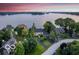 Breathtaking aerial view of a lakeside property with a long driveway and lush landscaping at 11715 Landings Dr, Indianapolis, IN 46256