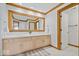 Bright bathroom with dual sinks, a large mirror, and white countertops at 11715 Landings Dr, Indianapolis, IN 46256