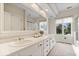 Modern bathroom with dual sinks, a large mirror, and a glass-enclosed shower at 11715 Landings Dr, Indianapolis, IN 46256