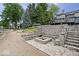 A luxurious stone patio with fire pit and beach access, perfect for outdoor entertaining and relaxing by the water at 11715 Landings Dr, Indianapolis, IN 46256