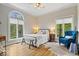 Cozy bedroom with hardwood floors, large windows, and a comfortable seating area to enjoy the outdoors at 11715 Landings Dr, Indianapolis, IN 46256