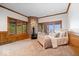 Cozy bedroom with wood paneling, a stone fireplace, and many windows at 11715 Landings Dr, Indianapolis, IN 46256