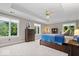 Spacious bedroom with tray ceiling, three windows, and comfortable furnishings at 11715 Landings Dr, Indianapolis, IN 46256