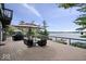 Spacious wooden deck featuring comfortable seating with a beautiful lake view at 11715 Landings Dr, Indianapolis, IN 46256
