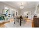 Bright dining area with hardwood floors, modern lighting, and entry to kitchen at 11715 Landings Dr, Indianapolis, IN 46256