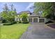Stunning stone home with a three-car garage and well-manicured landscaping at 11715 Landings Dr, Indianapolis, IN 46256