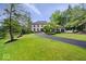 Beautiful stone home with mature trees and a lush green lawn at 11715 Landings Dr, Indianapolis, IN 46256