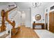 Elegant foyer with hardwood floors, staircase, and stylish decor create a grand entrance at 11715 Landings Dr, Indianapolis, IN 46256
