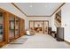 Bright foyer with wood trim, white tile flooring, and views into the living room and staircase at 11715 Landings Dr, Indianapolis, IN 46256