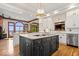 Bright kitchen with marble island, white cabinets, stainless steel appliances, and hardwood floors at 11715 Landings Dr, Indianapolis, IN 46256