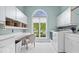 Bright laundry room with white cabinets, modern machines, and ample counter space at 11715 Landings Dr, Indianapolis, IN 46256