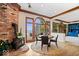 Cozy dining room features hardwood floors, brick hearth and views of the lake at 11715 Landings Dr, Indianapolis, IN 46256
