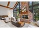 Inviting living room features a brick fireplace, large windows, and stylish furnishings at 11715 Landings Dr, Indianapolis, IN 46256