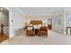 Bright main bedroom with a unique wood headboard, comfortable seating, and a view of the outdoors at 11715 Landings Dr, Indianapolis, IN 46256