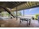 Covered patio featuring a ping pong table and partial views of the lake at 11715 Landings Dr, Indianapolis, IN 46256