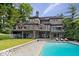 A beautiful stone home featuring a large pool and deck, perfect for outdoor entertaining at 11715 Landings Dr, Indianapolis, IN 46256