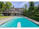 Stunning pool with diving board and stone accents, overlooking a beautiful multi-story home at 11715 Landings Dr, Indianapolis, IN 46256