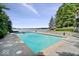 Large in-ground pool with stone surround and lake views, perfect for outdoor entertaining at 11715 Landings Dr, Indianapolis, IN 46256
